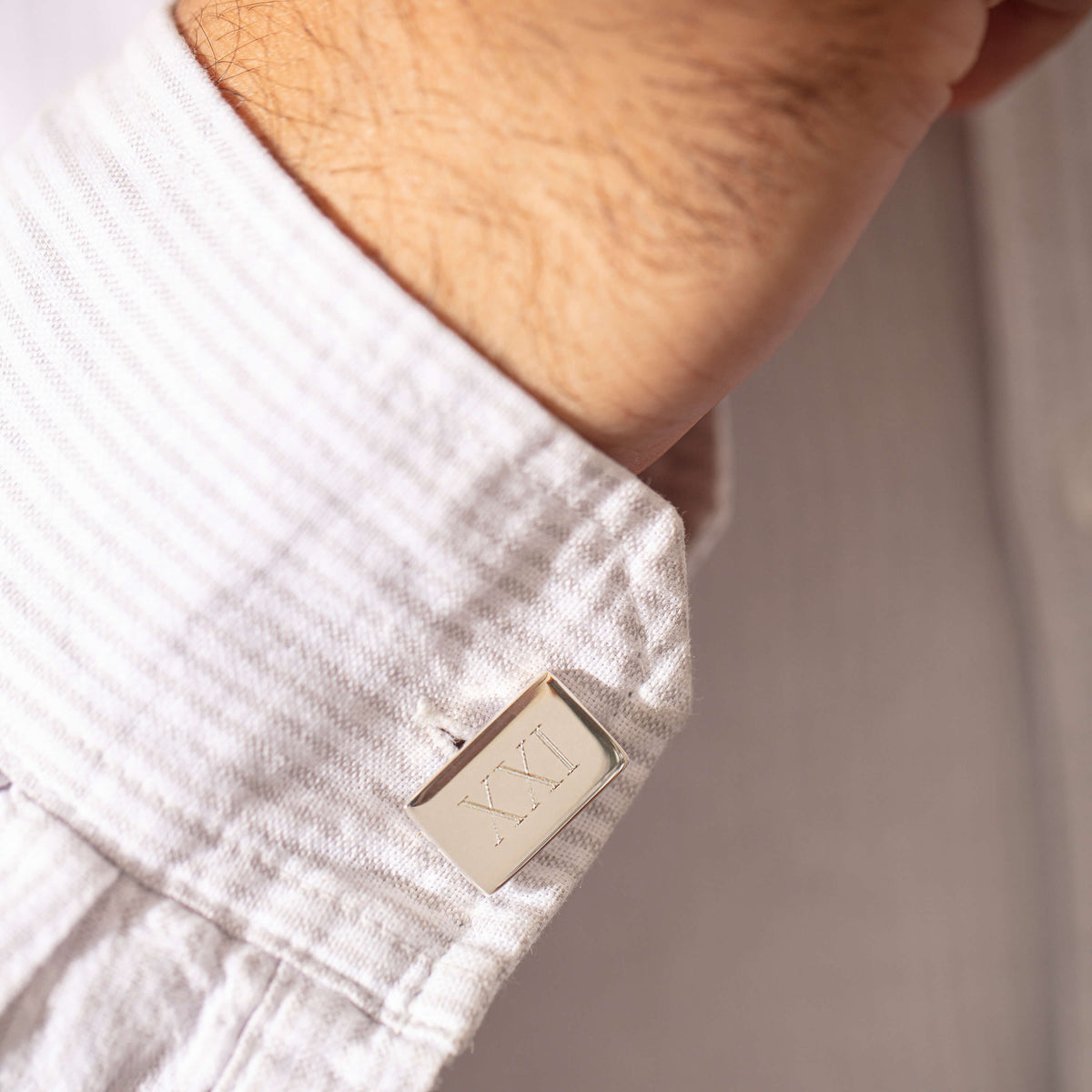 Model wearing sterling silver engraved cufflinks