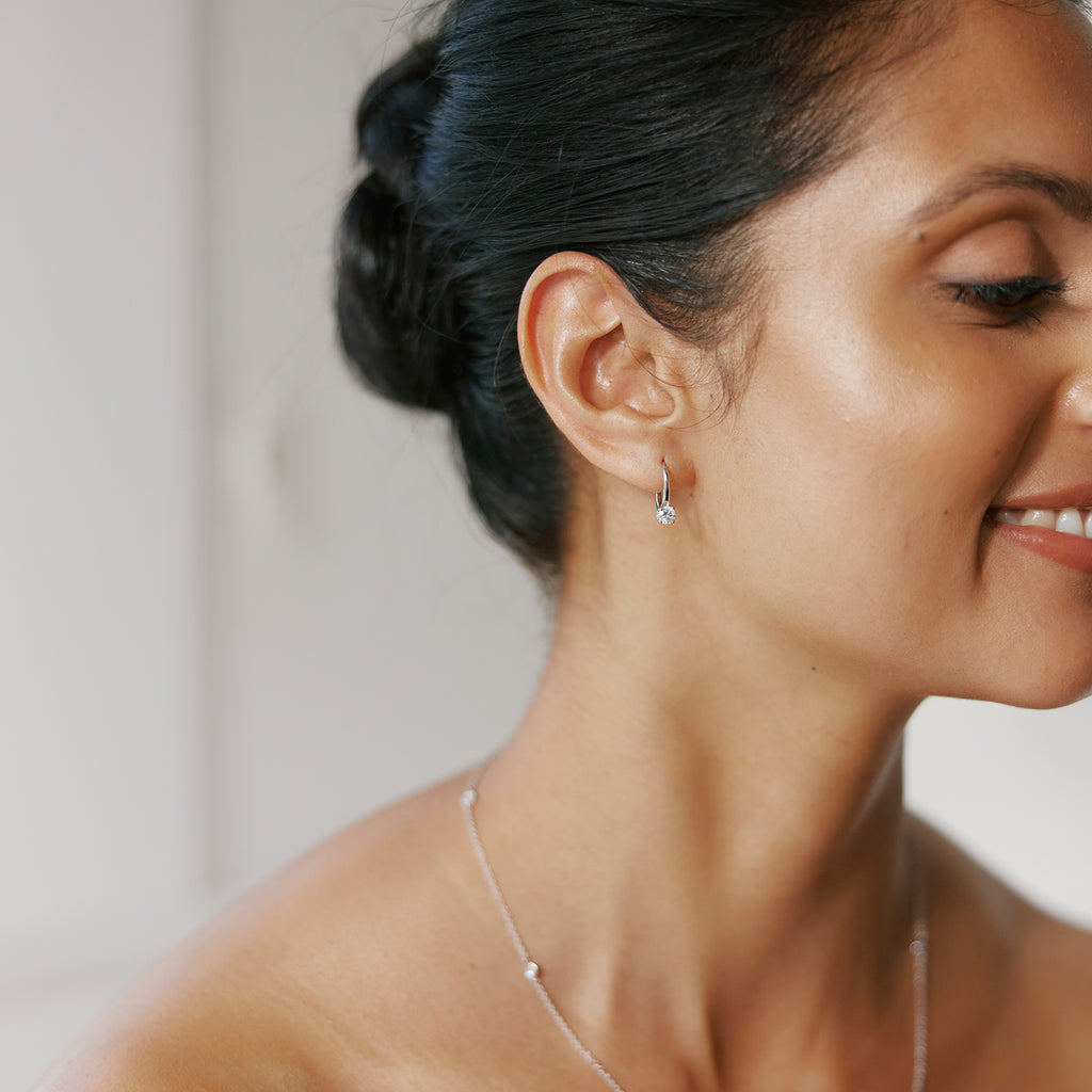 Bride wearing diamond earrings and necklace