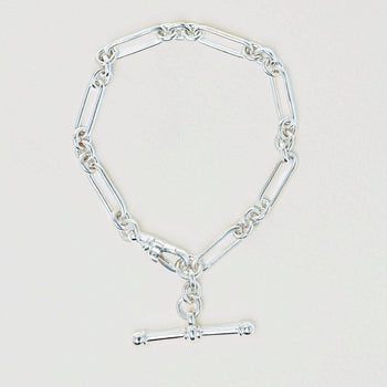 Sterling silver fob bracelet on a light grey background