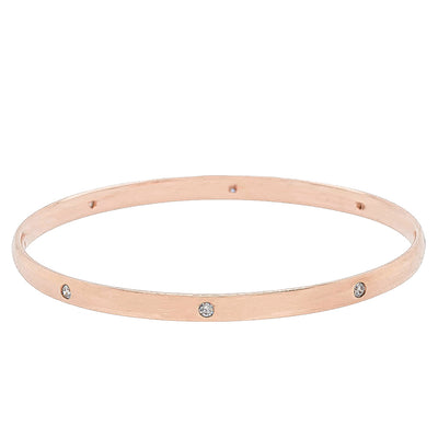 Rose gold bangle with embedded diamonds on a white background