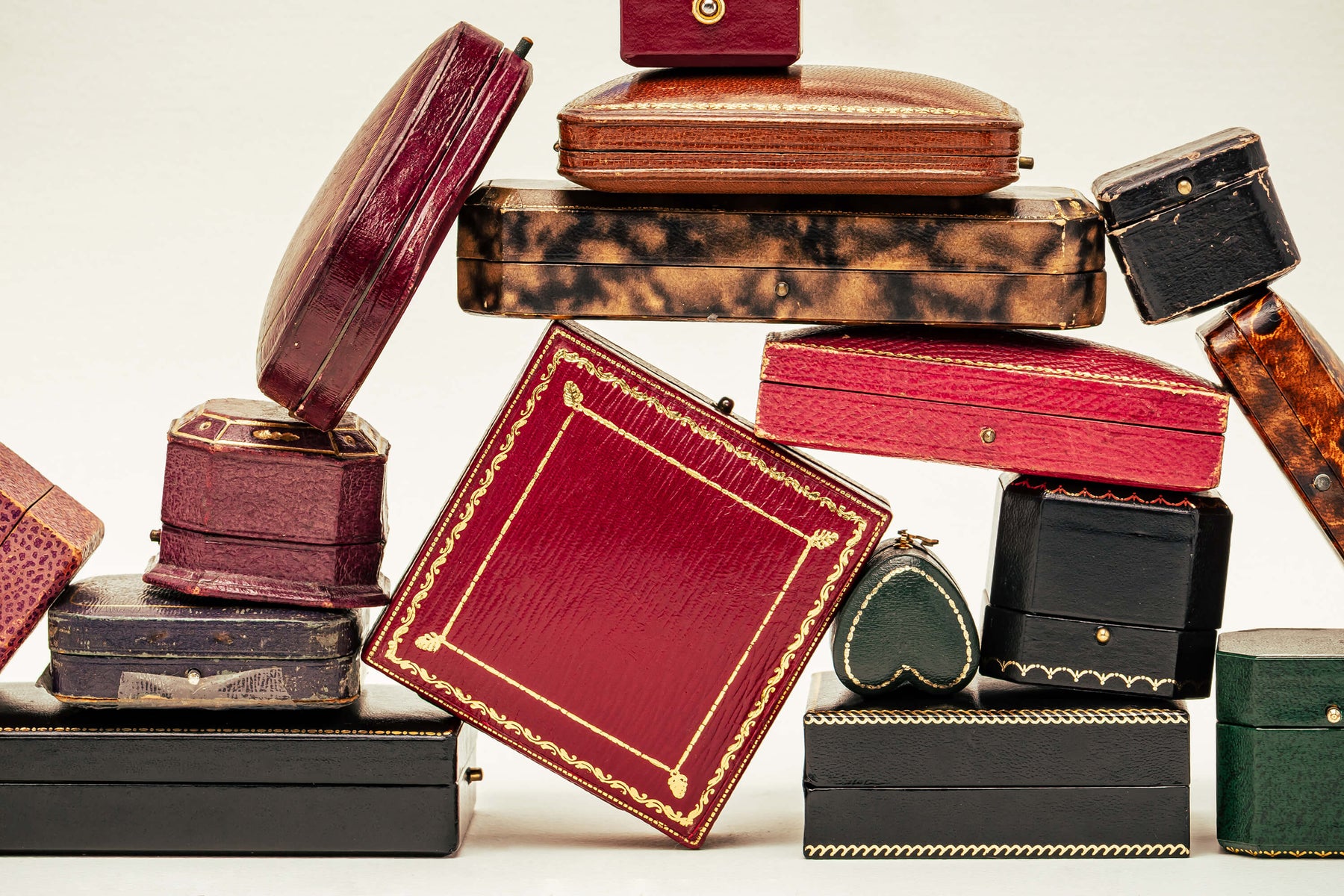 Collection of vintage jewellery and ring boxes stacked on top of one another