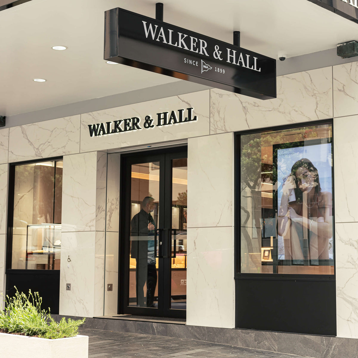 Walker & Hall store front with marble facade and glass doors.