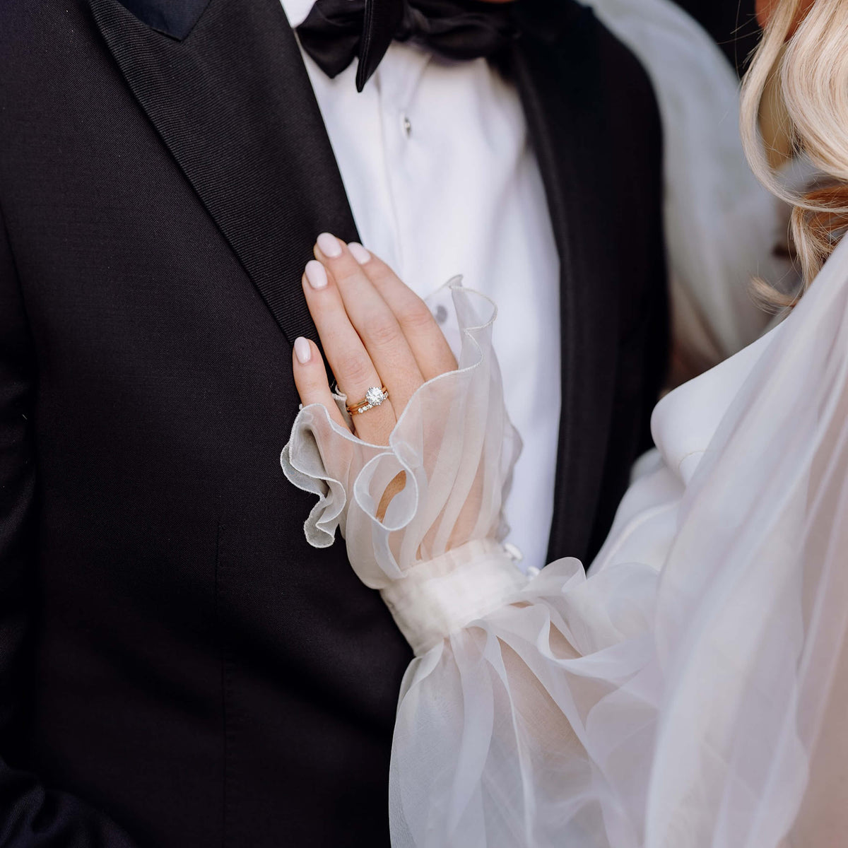 Bride and groom on their wedding day, bride wearing diamond engagement and wedding rings