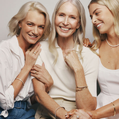 Mother, daughter and granddaughter wearing pearl, natural diamond and gemstone jewellery