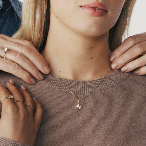 Close up of model wearing Gold Reflections Pendant