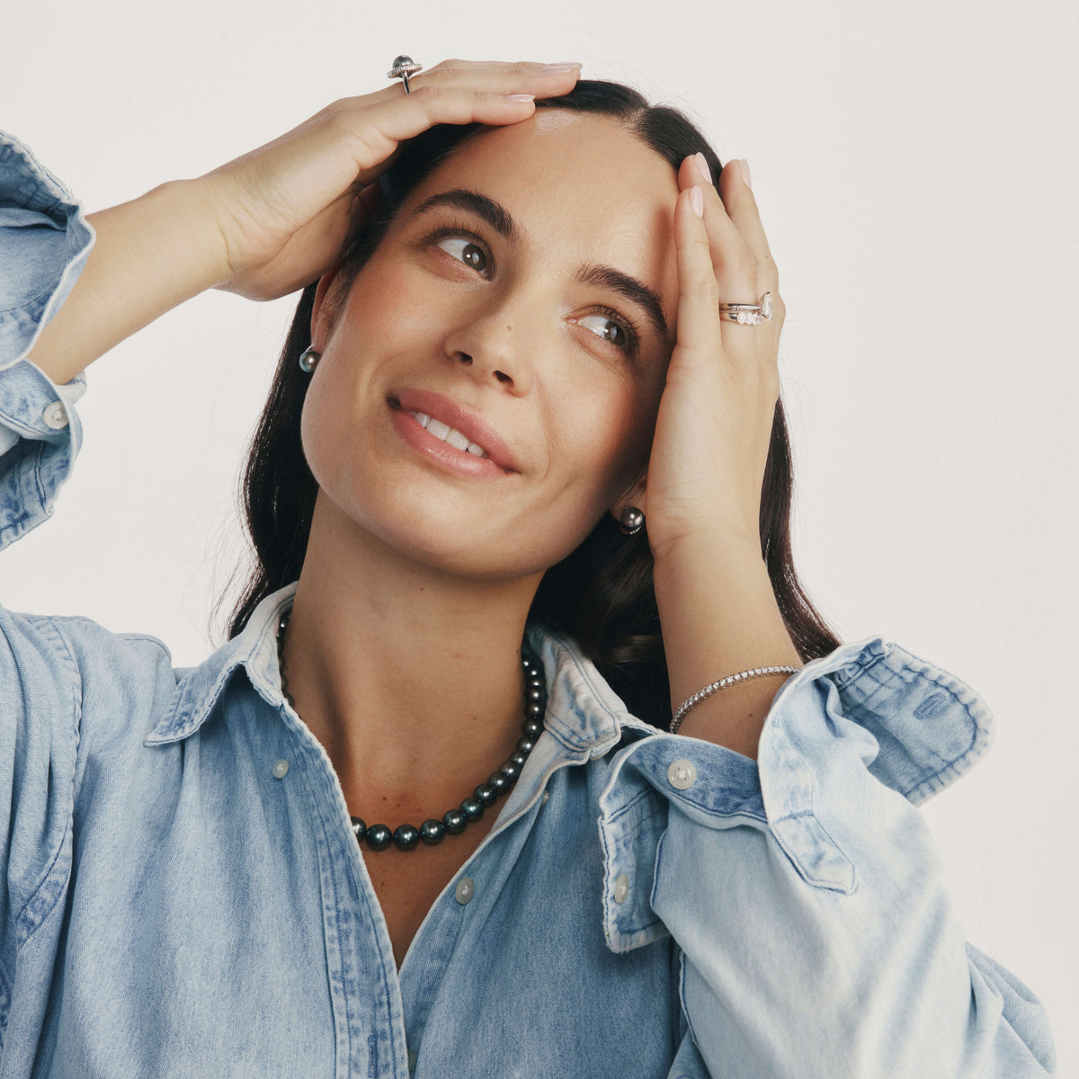 Model wearing denim shirt with Tahitian Pearl Strand, Ring and Diamond Rings and Diamond Bracelet
