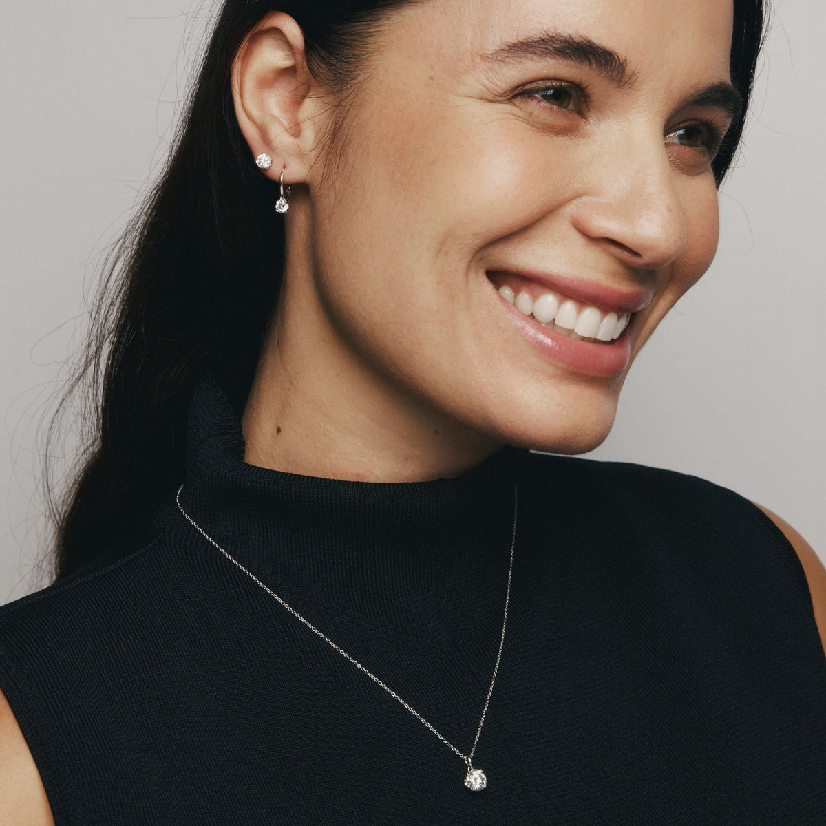 Woman smiling wearing Diamond Blossom Pendant and Blossom Studs and Drop Earrings