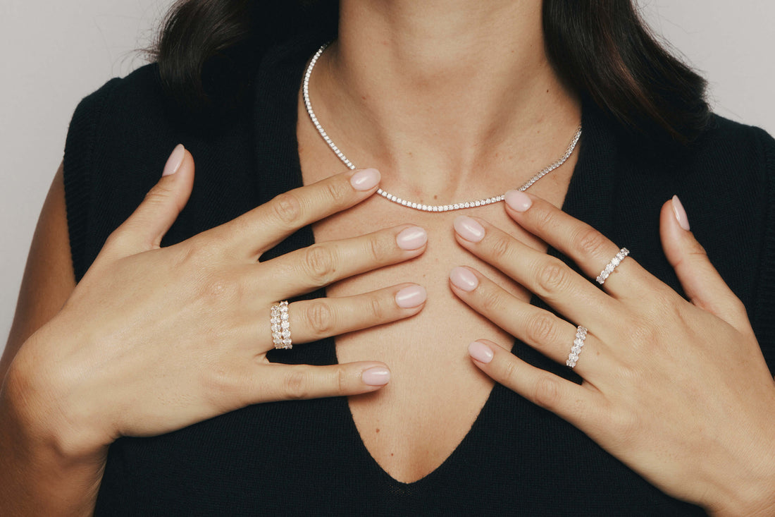Close up of model wearing Diamond Panorama Tennis Necklace and Diamond Panorama Rings