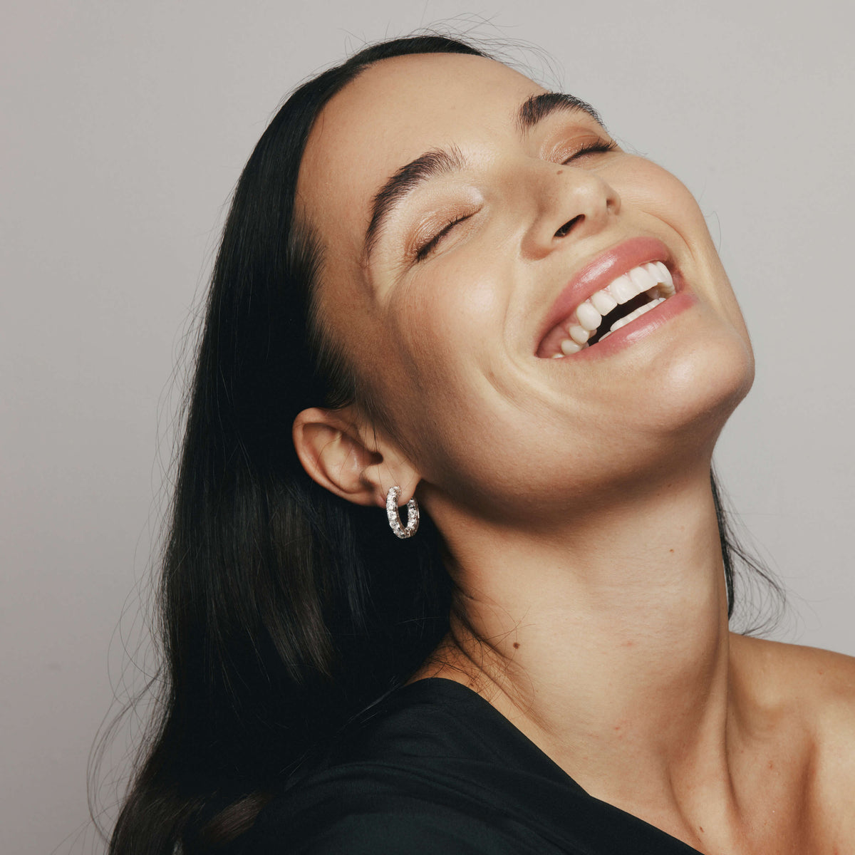 Woman smiling wearing diamond Jubilee Hoop Earrings