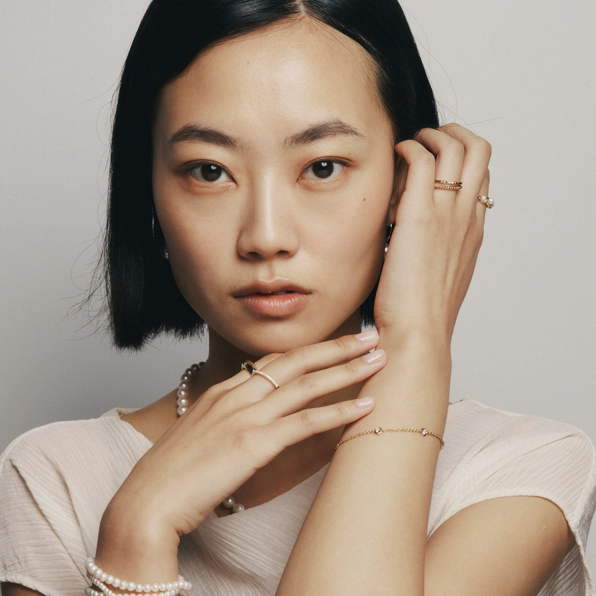 Model wearing gold, natural diamond and pearl jewellery