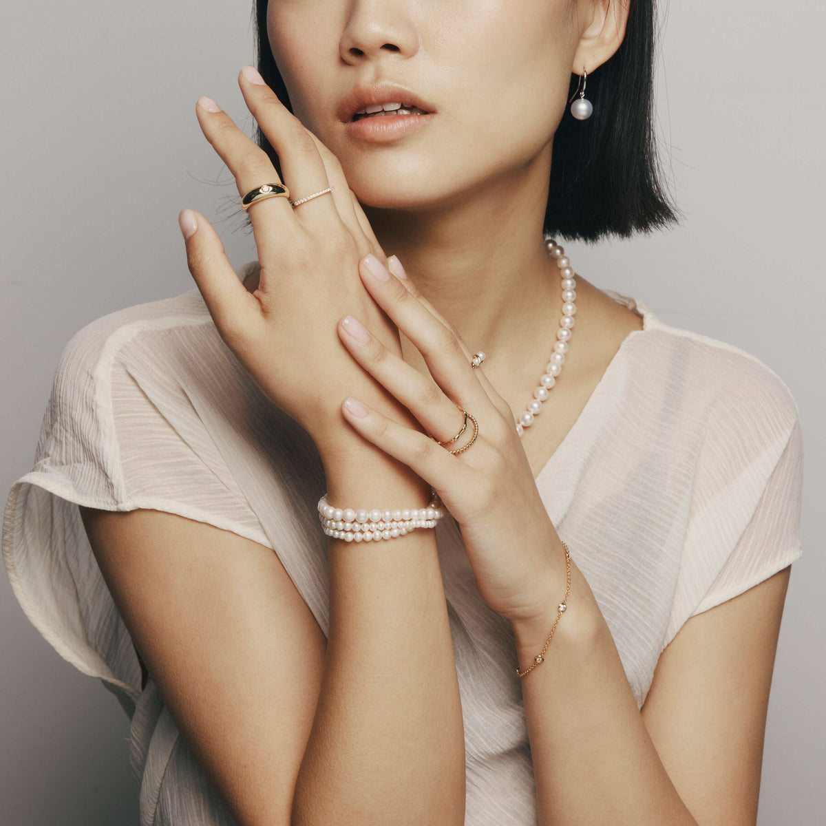 Model wearing gold, natural diamond and pearl jewellery