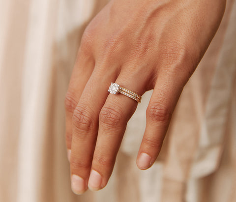 Model wearing diamond engagement and wedding rings