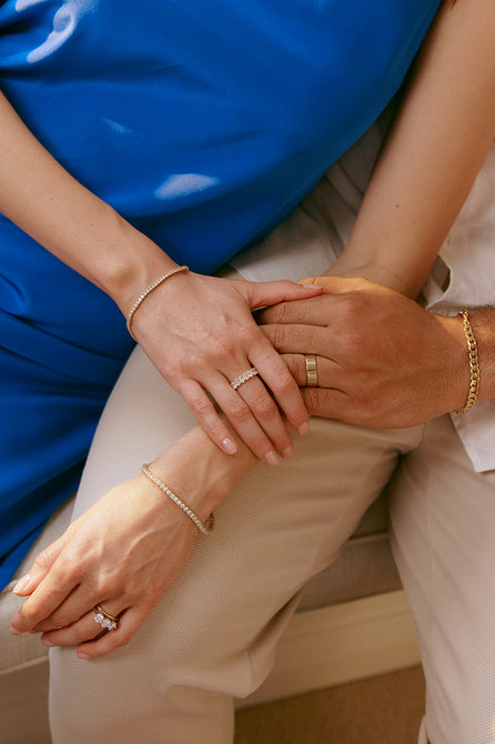 Couple holding hands wearing wedding and eternity rings