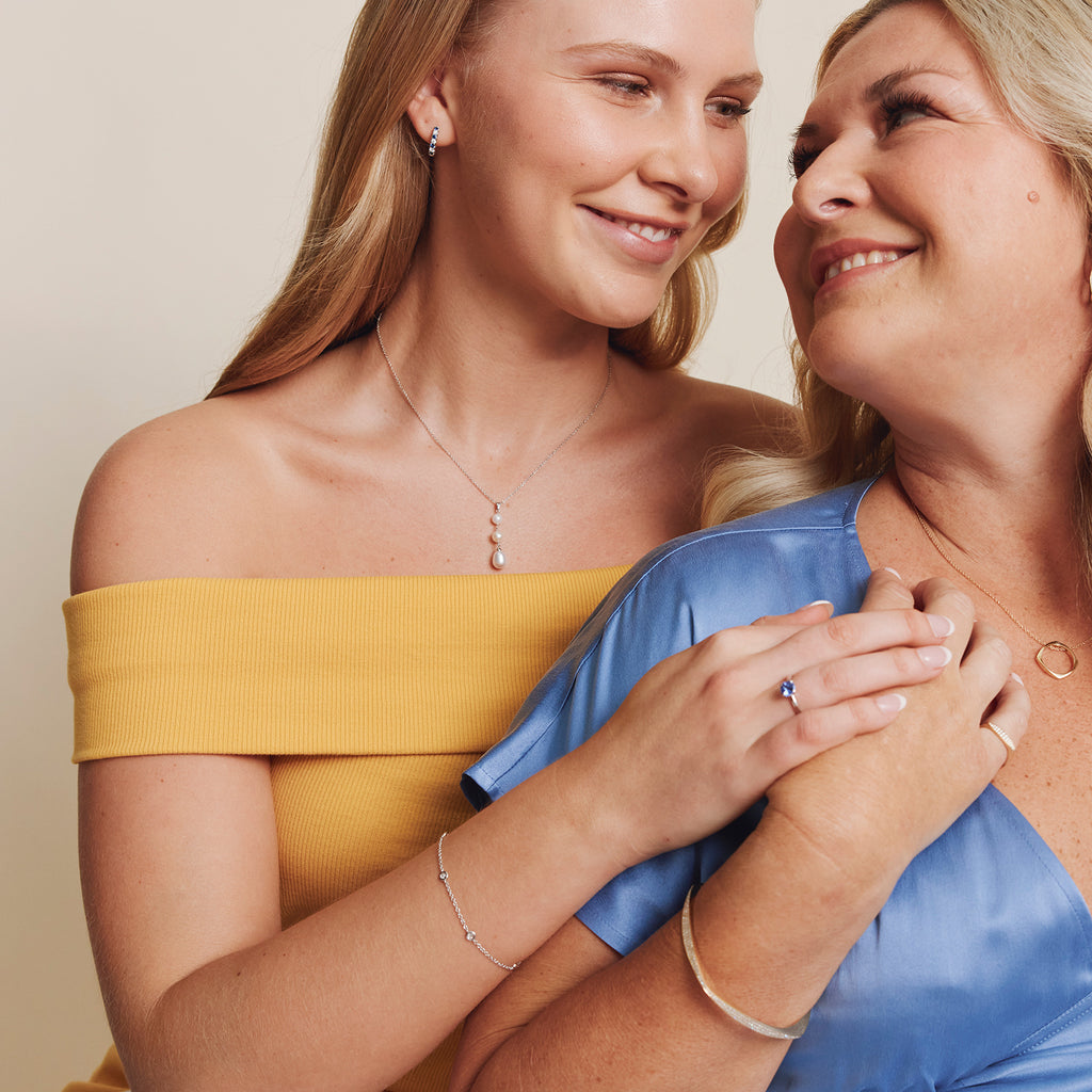 Mother and daughter wearing jewellery featuring birthstones