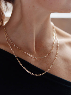 Model wearing recycled gold chains